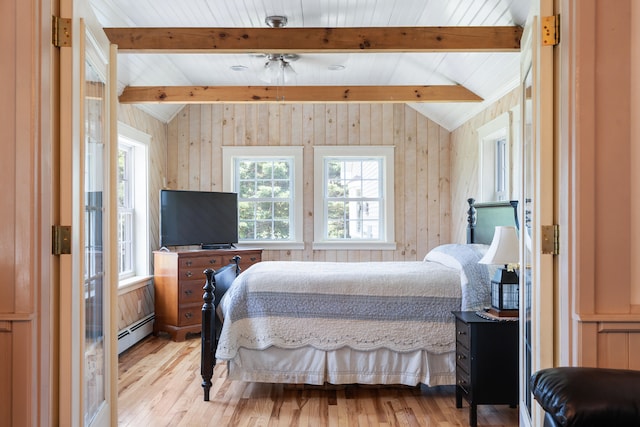 bedroom with a baseboard heating unit, wooden walls, lofted ceiling with beams, and light hardwood / wood-style floors