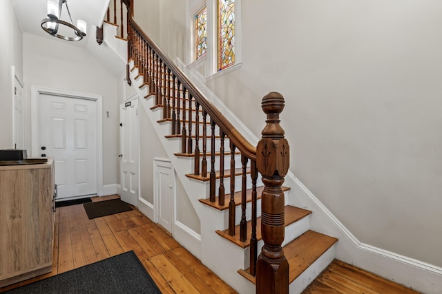 stairway featuring a chandelier and hardwood / wood-style flooring