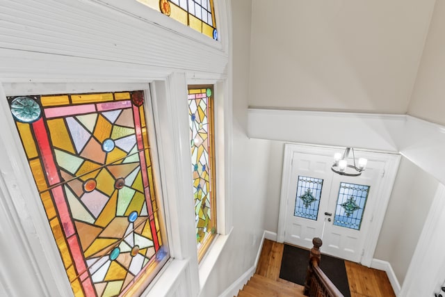 details featuring a chandelier, french doors, and hardwood / wood-style flooring