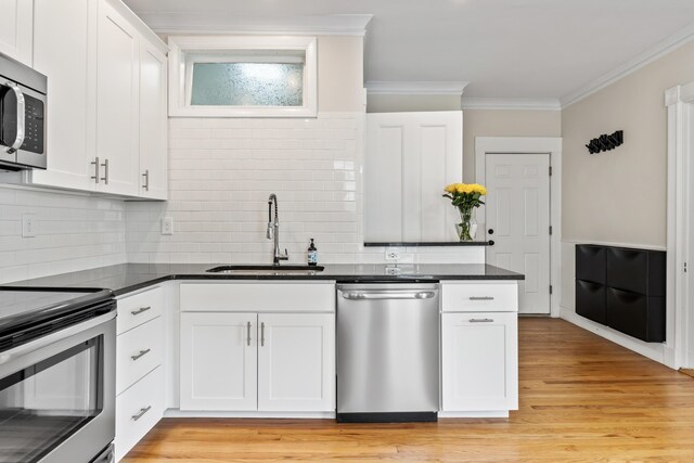 kitchen with sink, white cabinetry, and stainless steel appliances