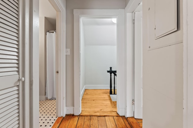 corridor with light hardwood / wood-style floors