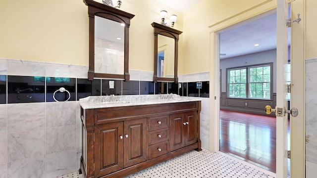 bathroom featuring tile walls and vanity