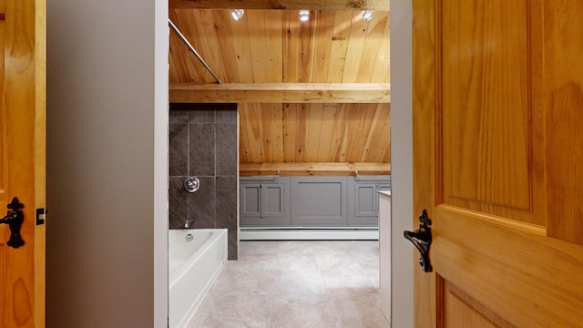 bathroom with a baseboard heating unit, a bathing tub, and wood walls