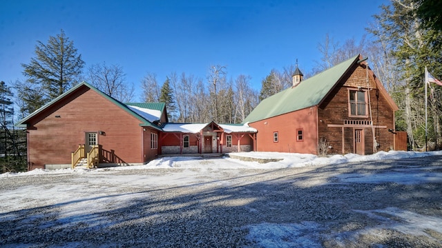 view of snow covered back of property