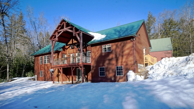 snow covered property with a deck