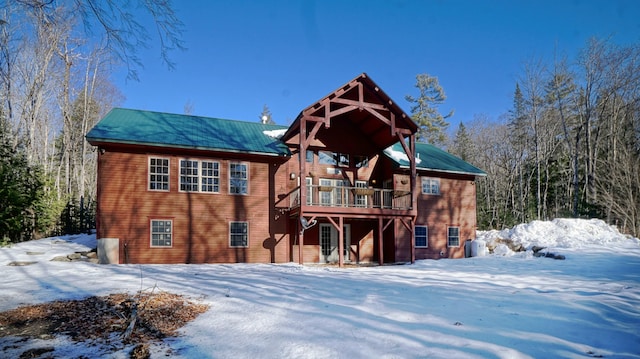 98 Kimball Rd, Harrison, ME 04040 - snow covered back of property with metal roof and a wooden deck