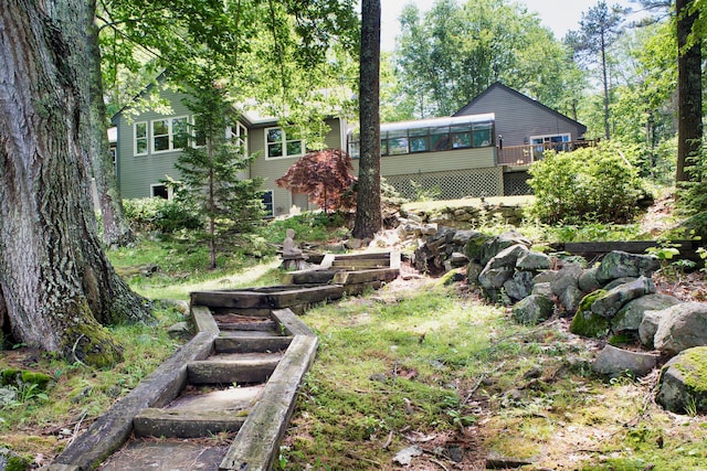 view of yard with a wooden deck and a sunroom