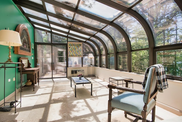 sunroom / solarium featuring plenty of natural light and vaulted ceiling