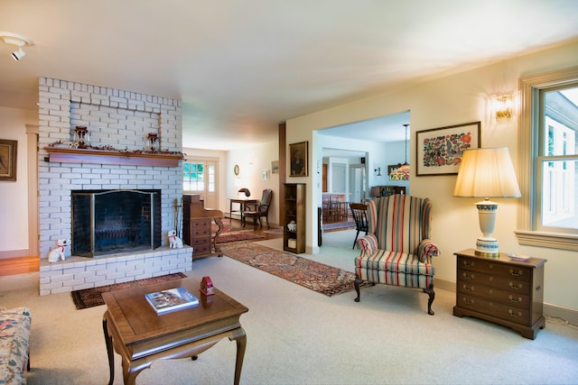 carpeted living room with a healthy amount of sunlight and a fireplace