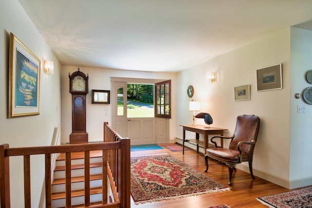 living area featuring a baseboard radiator and wood-type flooring