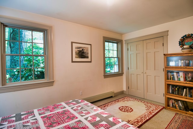 bedroom featuring a closet and a baseboard radiator