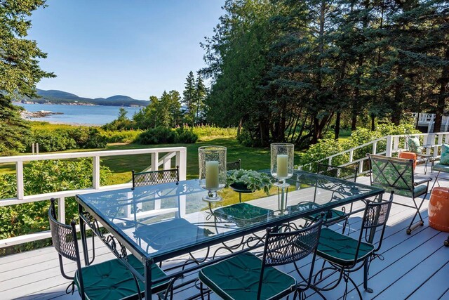 11 Bunkers Ledge Ln, Cranberry Isles, ME 04625 - deck with a lawn, outdoor dining area, and a water and mountain view