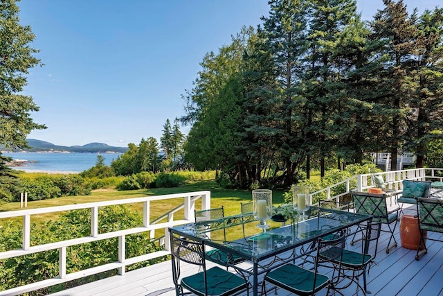 11 Bunkers Ledge Ln, Cranberry Isles, ME 04625 - deck featuring a water and mountain view, a lawn, and outdoor dining space