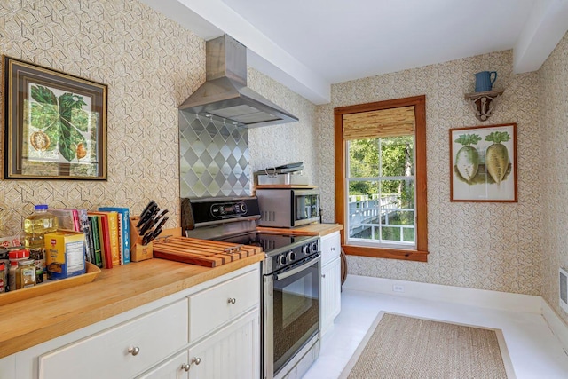 11 Bunkers Ledge Ln, Cranberry Isles, ME 04625 - kitchen with wallpapered walls, wooden counters, appliances with stainless steel finishes, and wall chimney exhaust hood