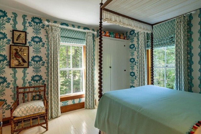 11 Bunkers Ledge Ln, Cranberry Isles, ME 04625 - bedroom featuring light wood-style flooring, wallpapered walls, and multiple windows