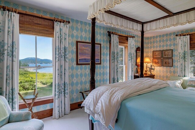 11 Bunkers Ledge Ln, Cranberry Isles, ME 04625 - bedroom with baseboards, wallpapered walls, and a water view