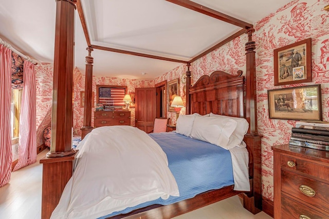 11 Bunkers Ledge Ln, Cranberry Isles, ME 04625 - bedroom with beamed ceiling, wallpapered walls, light wood-style floors, and ornate columns