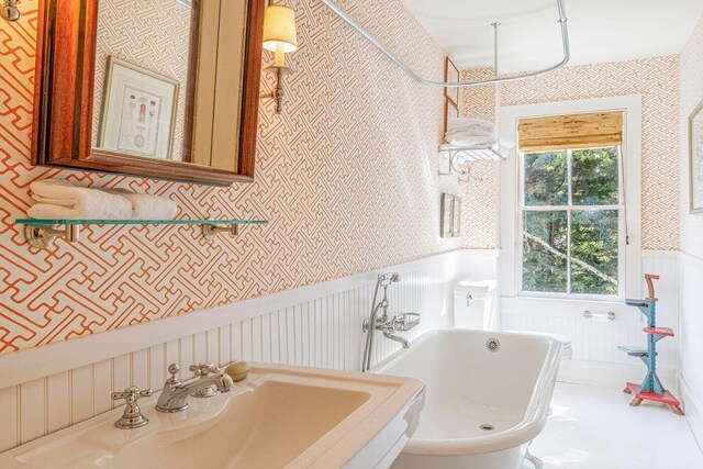 11 Bunkers Ledge Ln, Cranberry Isles, ME 04625 - full bath featuring a wainscoted wall, wallpapered walls, a freestanding bath, and a sink