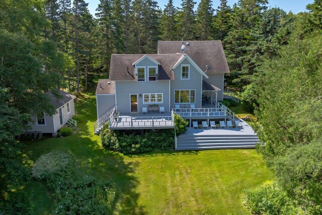 11 Bunkers Ledge Ln, Cranberry Isles, ME 04625 - rear view of property with a wooden deck, a forest view, and a lawn