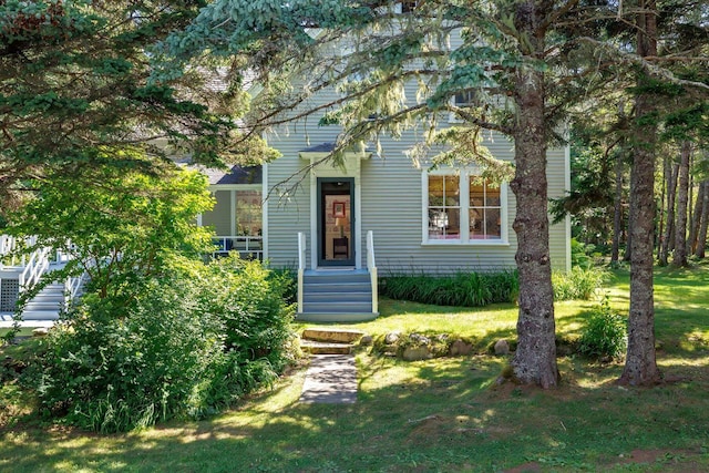 obstructed view of property featuring a front yard