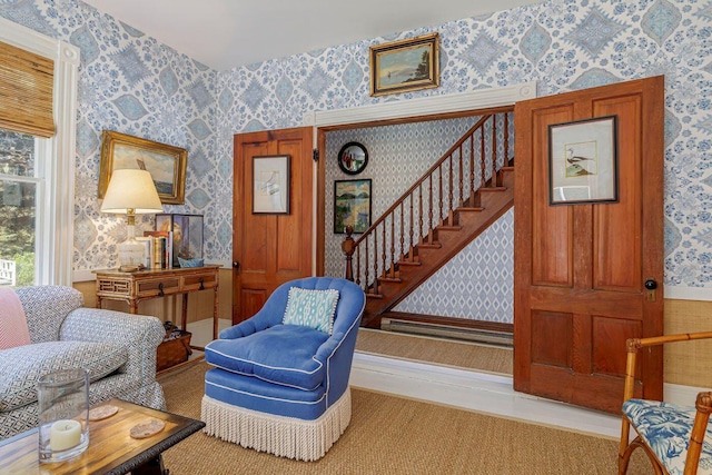11 Bunkers Ledge Ln, Cranberry Isles, ME 04625 - sitting room featuring wallpapered walls, stairs, and wainscoting
