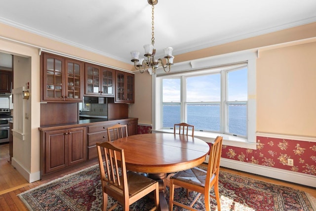 LTS23A Birch Is, South Bristol, ME 04568 - dining space featuring a chandelier, light wood-style floors, plenty of natural light, baseboard heating, and crown molding