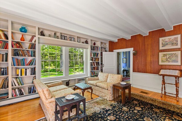 LTS23A Birch Is, South Bristol, ME 04568 - sitting room with beamed ceiling, wooden walls, wood finished floors, and a baseboard heating unit