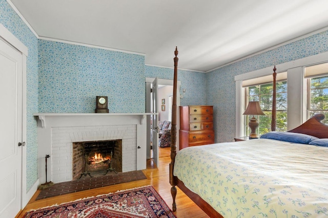 LTS23A Birch Is, South Bristol, ME 04568 - bedroom with wood finished floors, wallpapered walls, a fireplace, and ornamental molding