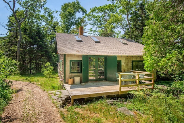 LTS23A Birch Is, South Bristol, ME 04568 - back of house featuring roof with shingles, a deck, a chimney, and an outbuilding