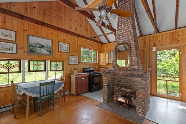 LTS23A Birch Is, South Bristol, ME 04568 - dining area with a ceiling fan, beam ceiling, wood walls, light wood-style flooring, and high vaulted ceiling
