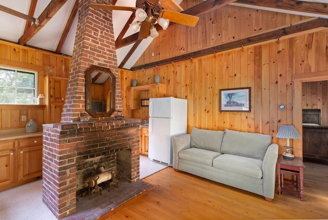 LTS23A Birch Is, South Bristol, ME 04568 - living area featuring wood walls, beamed ceiling, high vaulted ceiling, a ceiling fan, and light wood finished floors