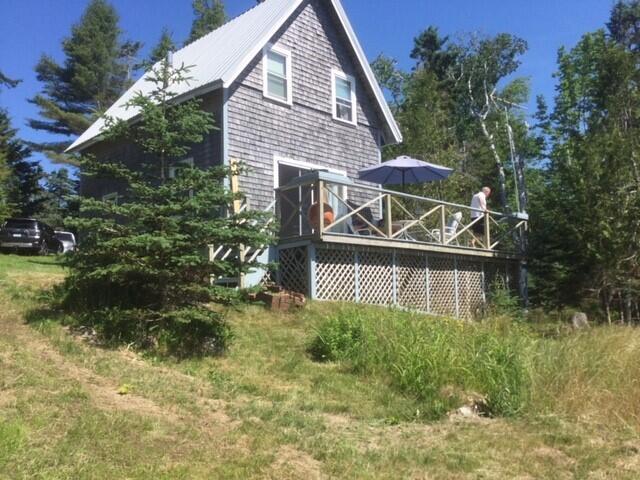 rear view of property with a wooden deck