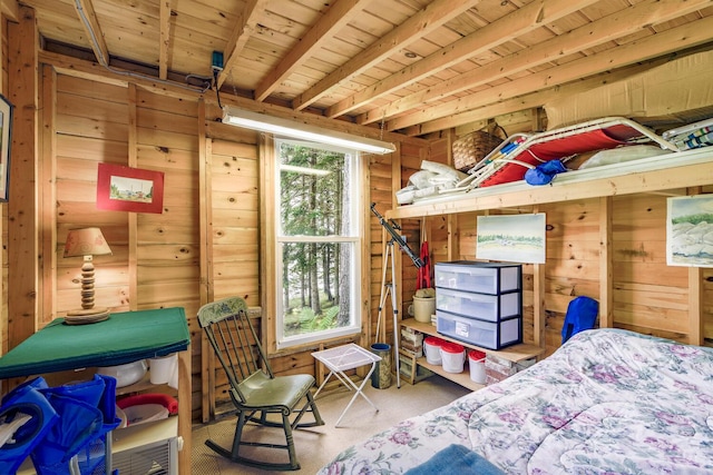 bedroom with carpet floors, wood ceiling, and wooden walls