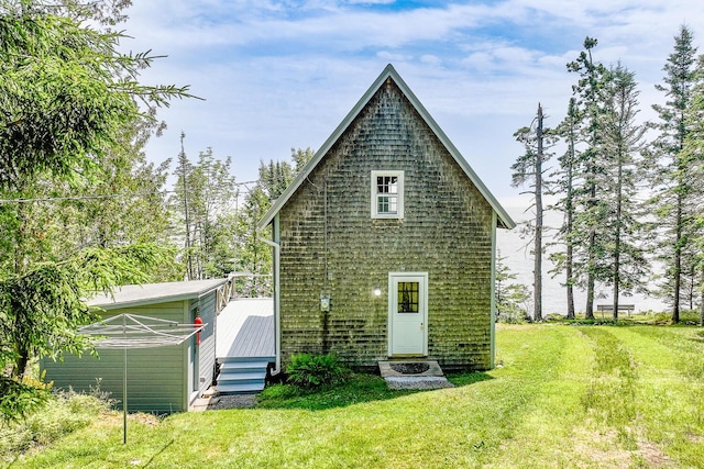 back of property featuring a yard