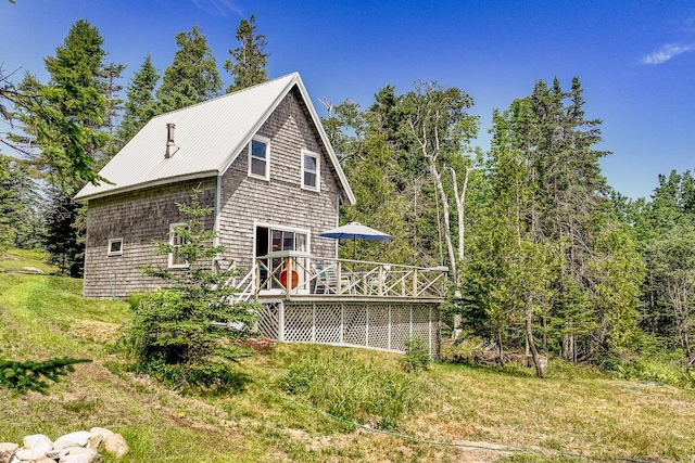 rear view of house featuring a wooden deck