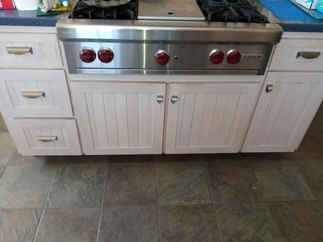 room details featuring stainless steel gas cooktop and white cabinetry