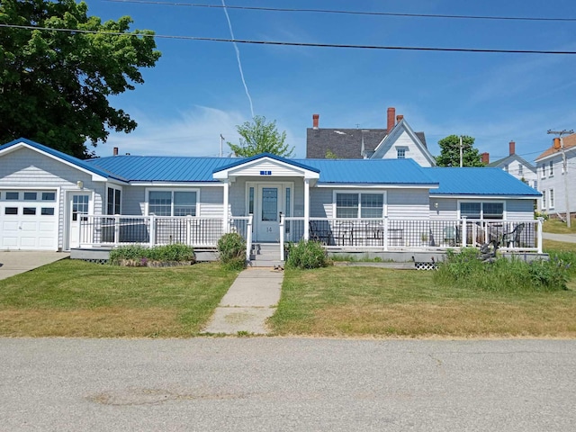 view of front of property with a front yard and a garage