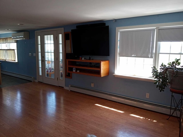 unfurnished living room with dark wood-type flooring, a baseboard heating unit, and a wall unit AC