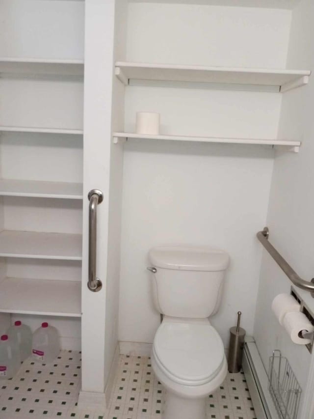 bathroom featuring toilet and baseboard heating