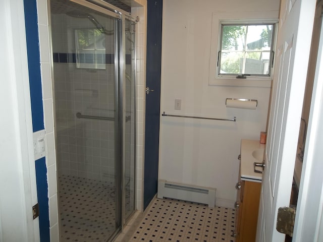 bathroom with vanity, an enclosed shower, and a baseboard radiator