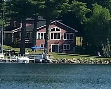 back of property featuring a water view