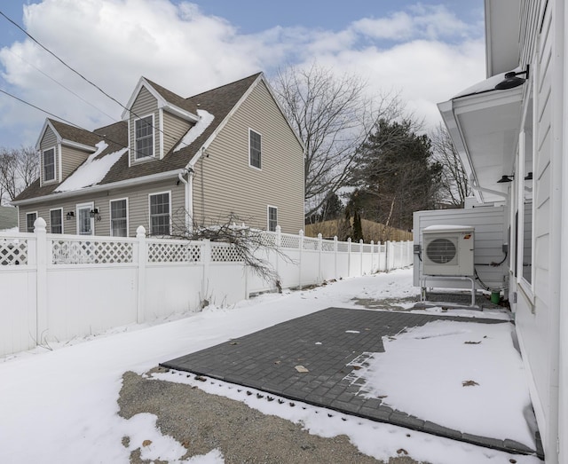 yard layered in snow with ac unit