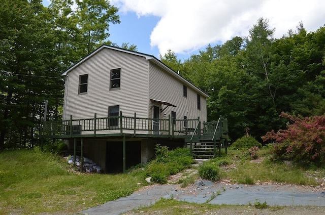 back of property featuring a wooden deck