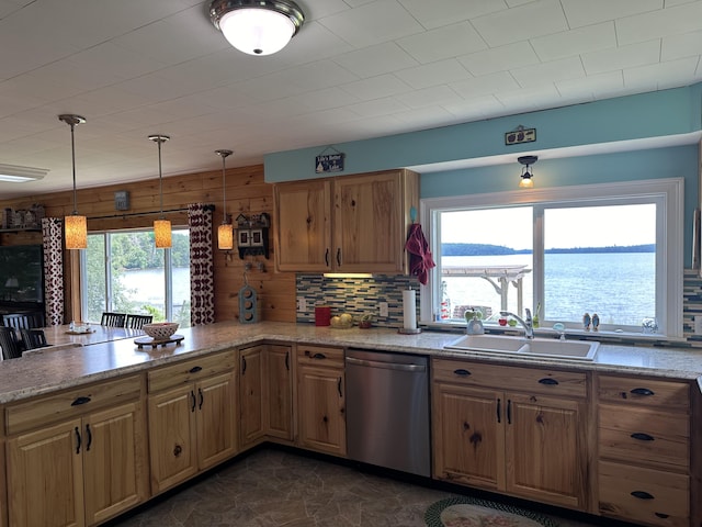 kitchen with decorative light fixtures, dishwasher, sink, decorative backsplash, and a water view