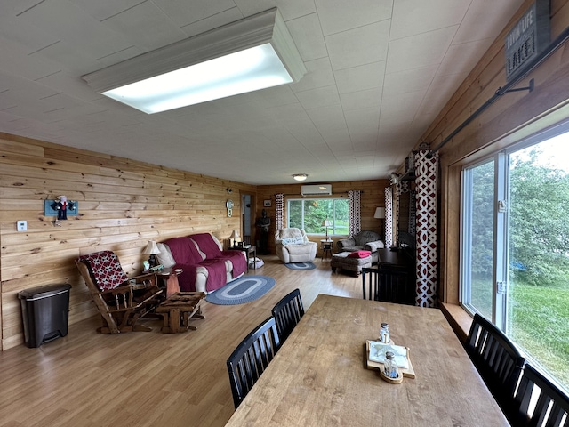 dining area featuring hardwood / wood-style floors and wood walls