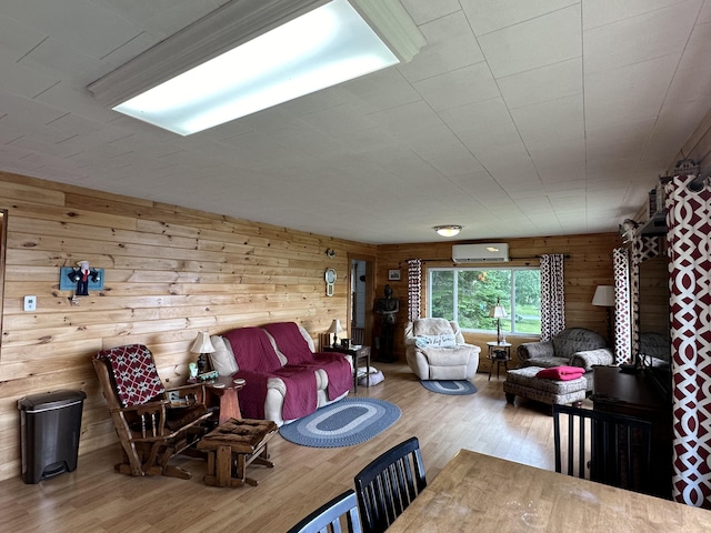 living room featuring hardwood / wood-style flooring, a wall mounted AC, and wooden walls