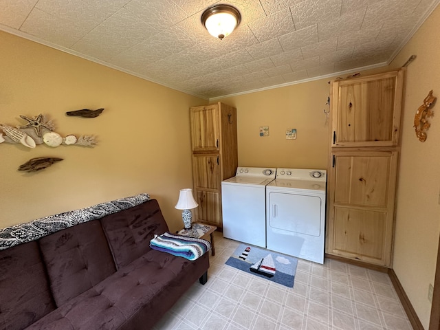 laundry room featuring cabinets, crown molding, and independent washer and dryer