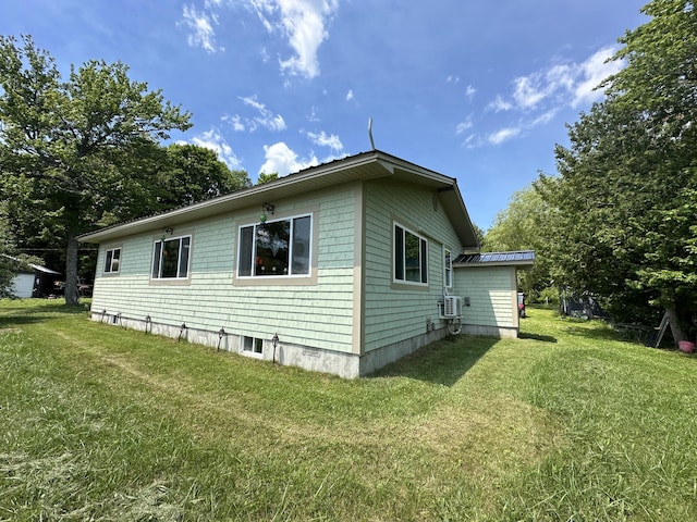 view of side of home featuring a lawn