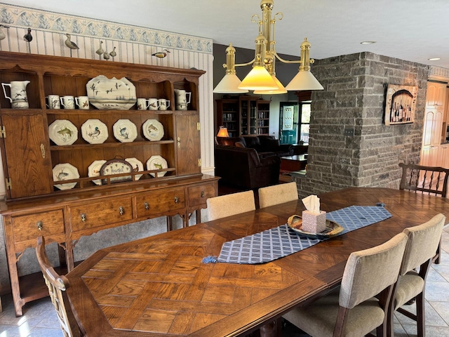 dining room with brick wall and light tile patterned flooring