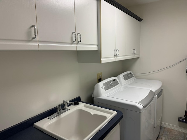 clothes washing area featuring cabinets, separate washer and dryer, and sink